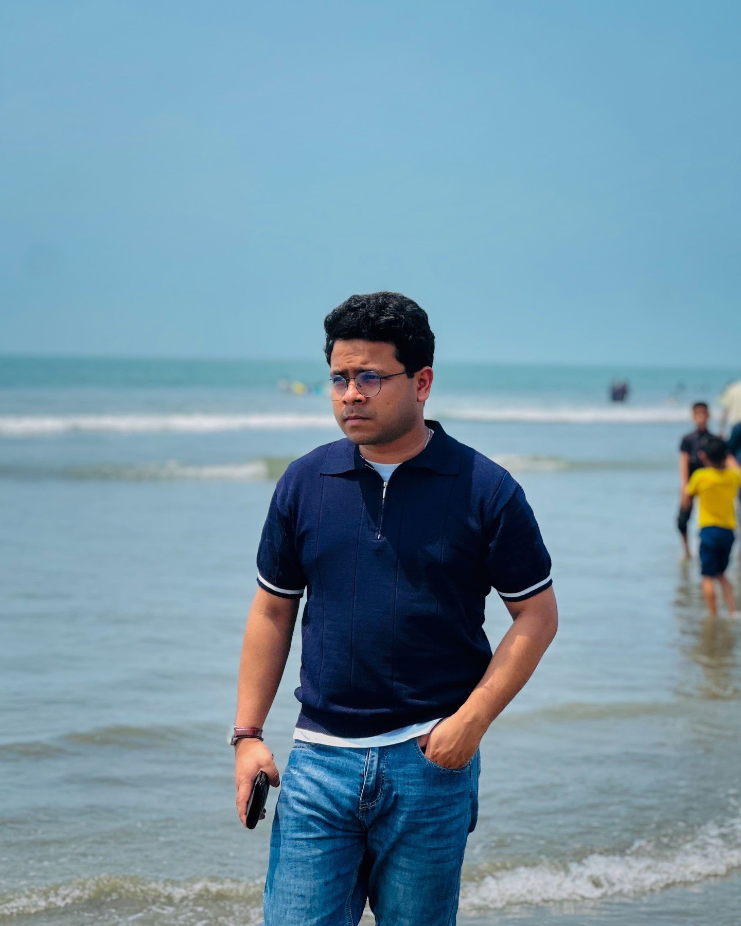 Hasnat Jani Rafin standing by the sea in a navy shirt